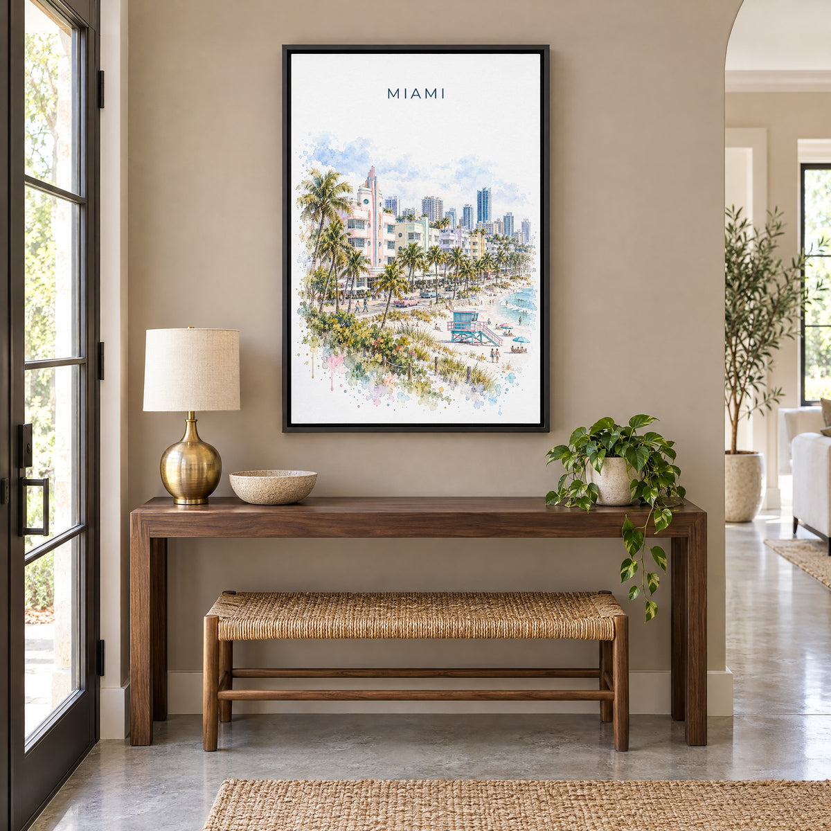 Miami watercolor print as a black floater canvas above a walnut console and woven bench in an entryway