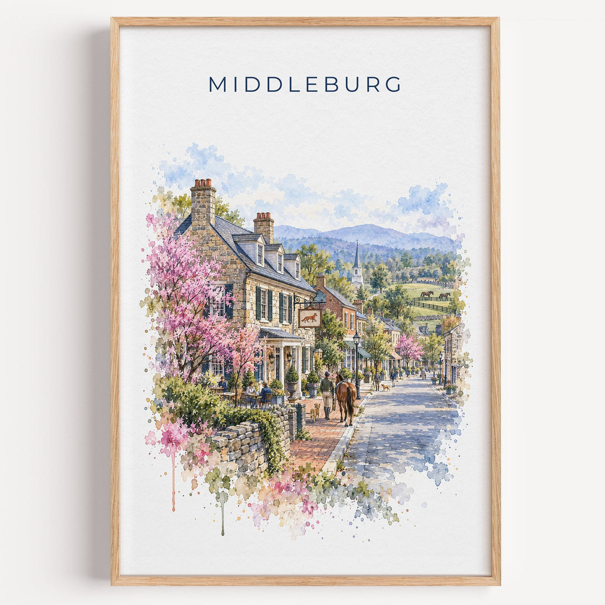 Middleburg, Virginia watercolor print in a light oak frame on a plain white wall
