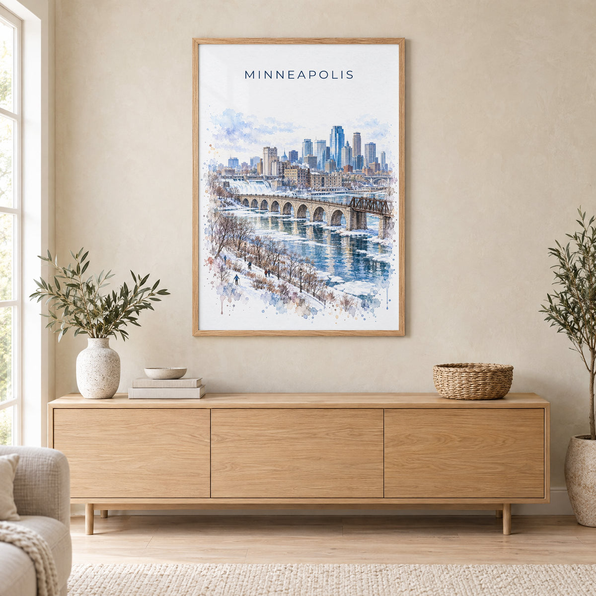 Minneapolis watercolor print in an oak frame above a light wood sideboard in a Scandinavian living room
