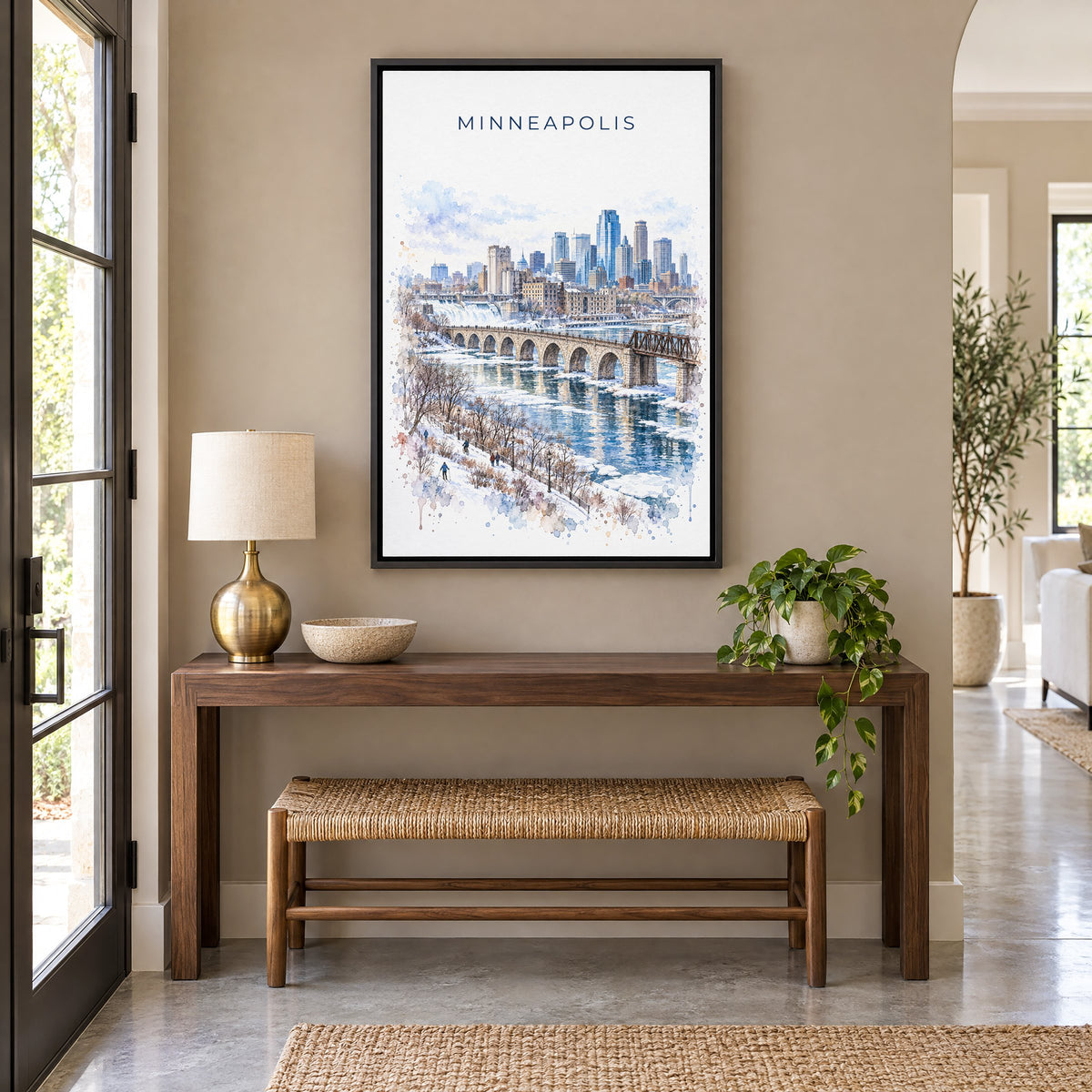 Minneapolis watercolor print as a black floater canvas above a walnut console and woven bench in an entryway