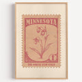 Minnesota state flower stamp print in rose red on blush pink, light oak frame on a plain white wall