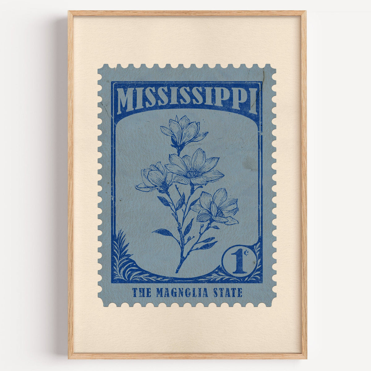 Mississippi state flower stamp print in ink blue on slate, light oak frame on a plain white wall