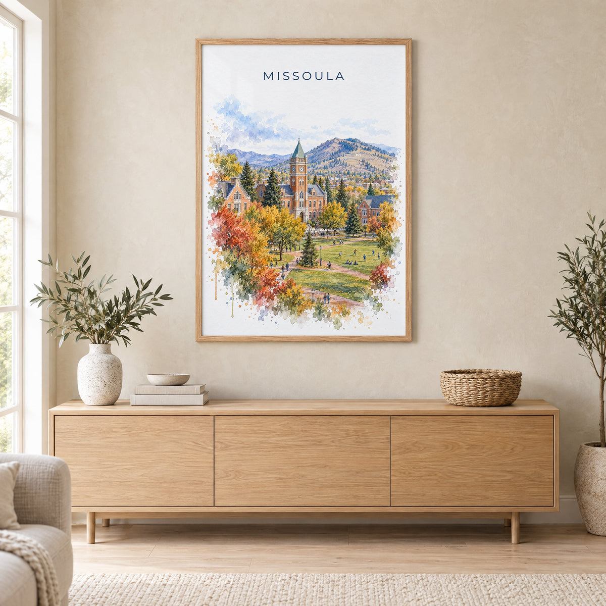 Missoula watercolor print in an oak frame above a light wood sideboard in a Scandinavian living room