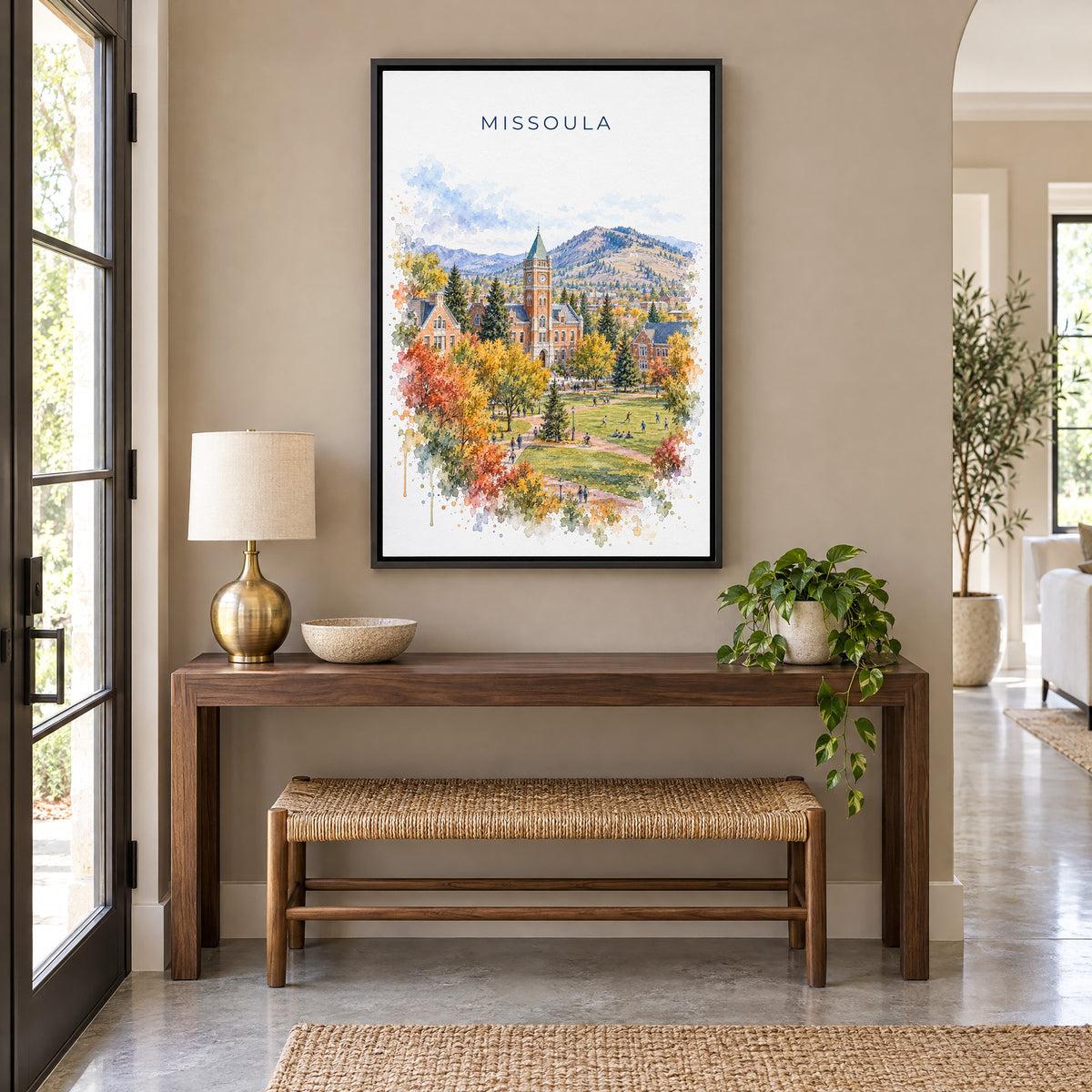 Missoula watercolor print as a black floater canvas above a walnut console and woven bench in an entryway