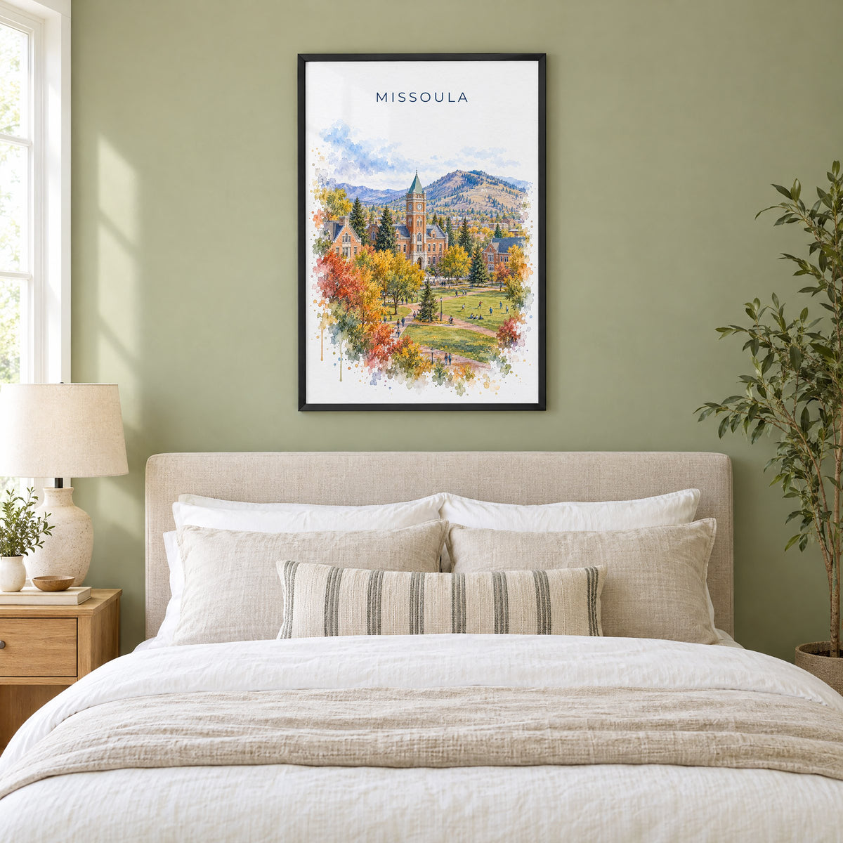 Missoula watercolor print in a black frame above an upholstered headboard in a sage green bedroom