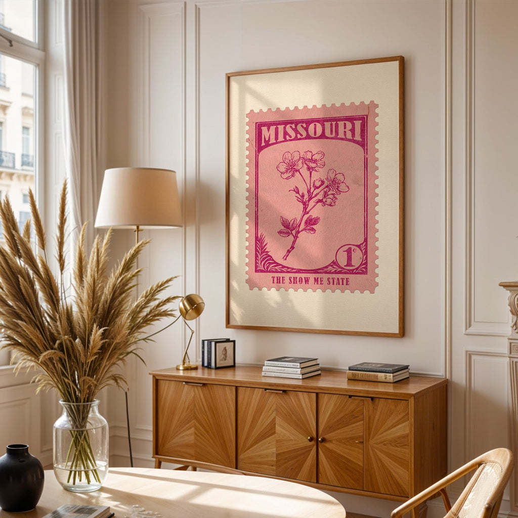Missouri stamp print framed above a wooden sideboard, pampas grass in a glass vase and a floor lamp