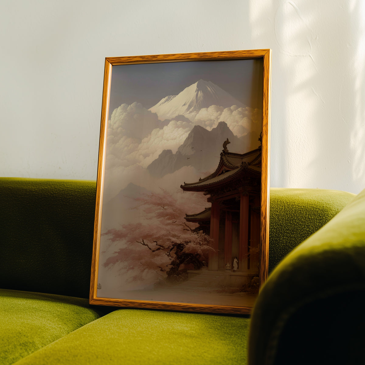 Misty sepia Mount Fuji temple print in an oak frame propped on a green velvet sofa