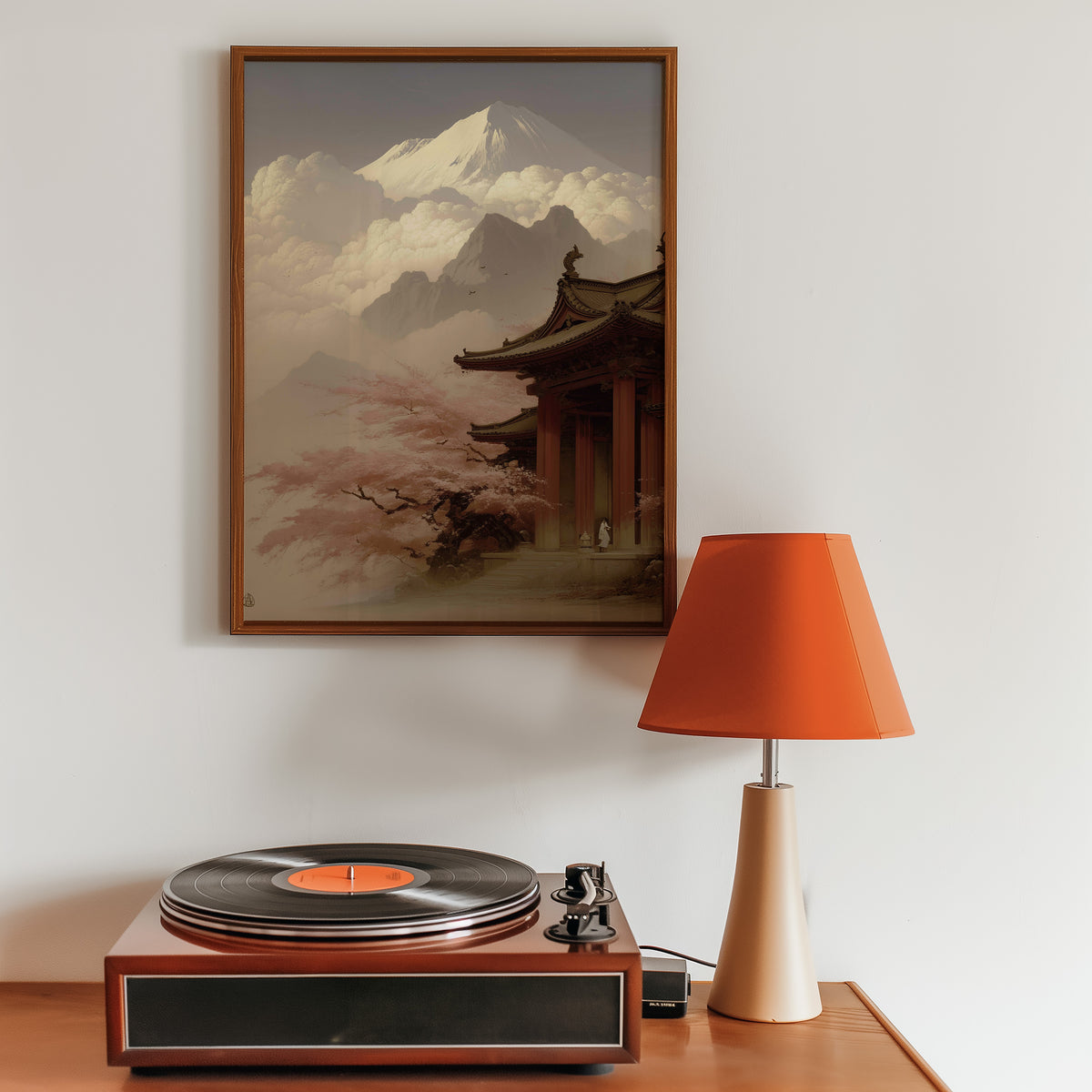 Misty sepia Mount Fuji temple print in a walnut frame above a sideboard with a record player