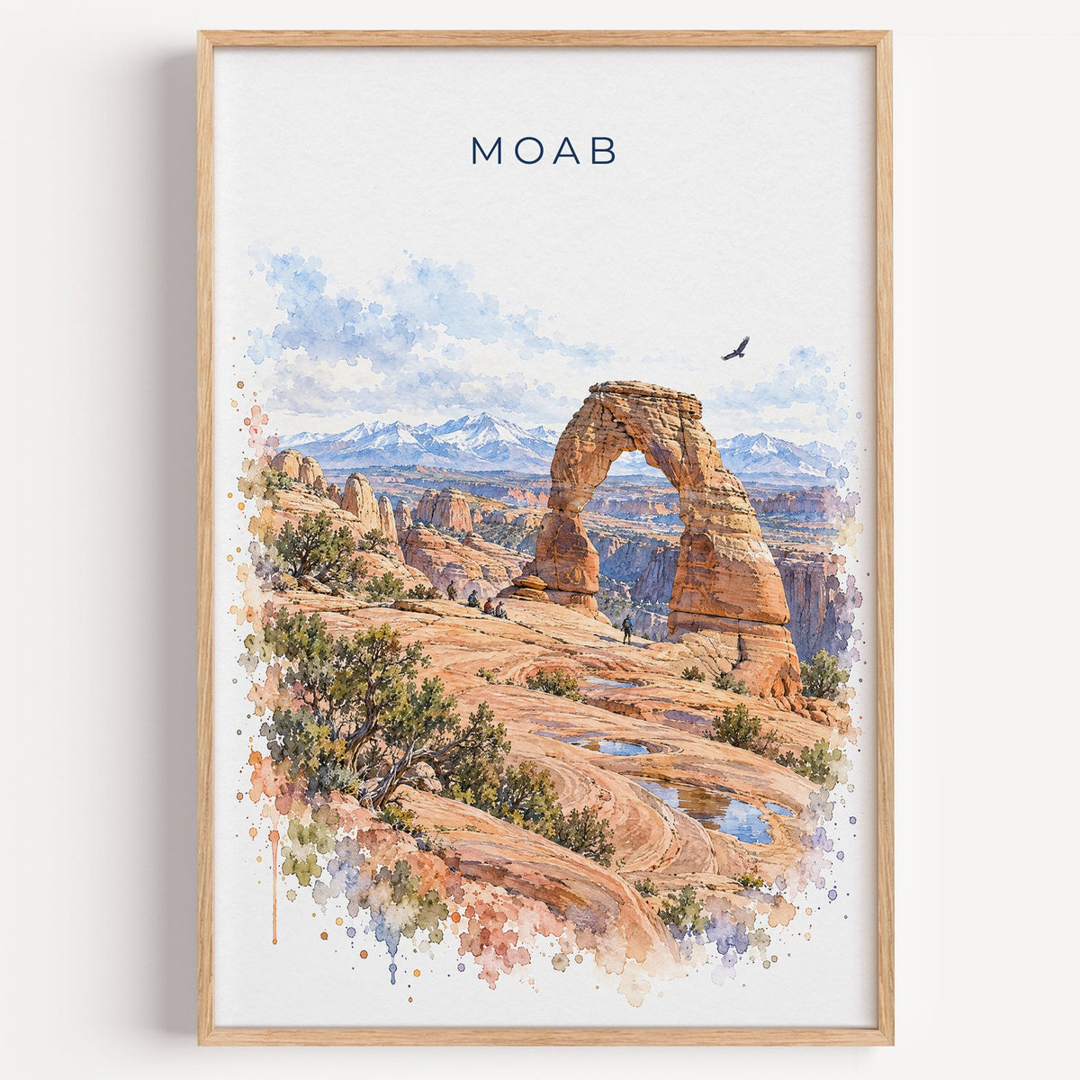 Moab watercolor print in a light oak frame on a plain white wall