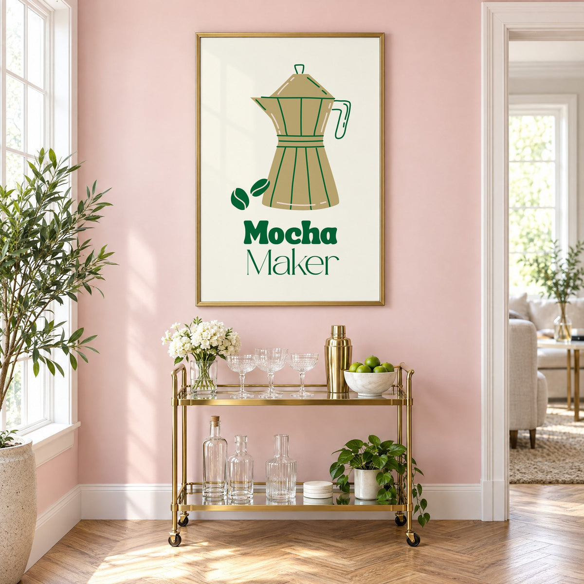 Mocha Maker gold moka pot and beans print in a brass frame on a blush pink wall above a gold bar cart with glassware