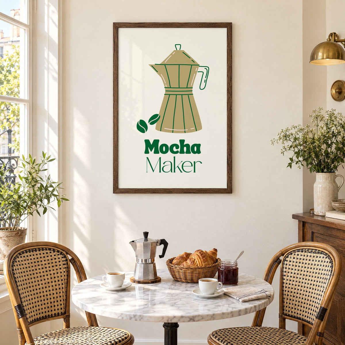 Mocha Maker gold moka pot and beans print in a walnut frame above a marble bistro table with croissants and rattan chairs