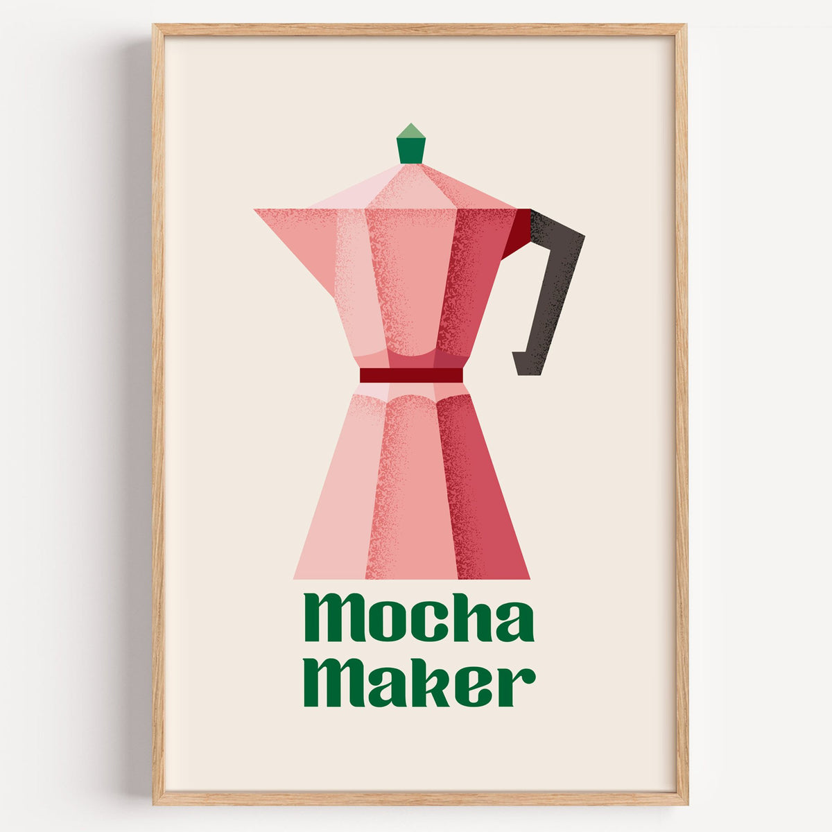 Mocha Maker pink moka pot print in a light oak frame on a plain white wall