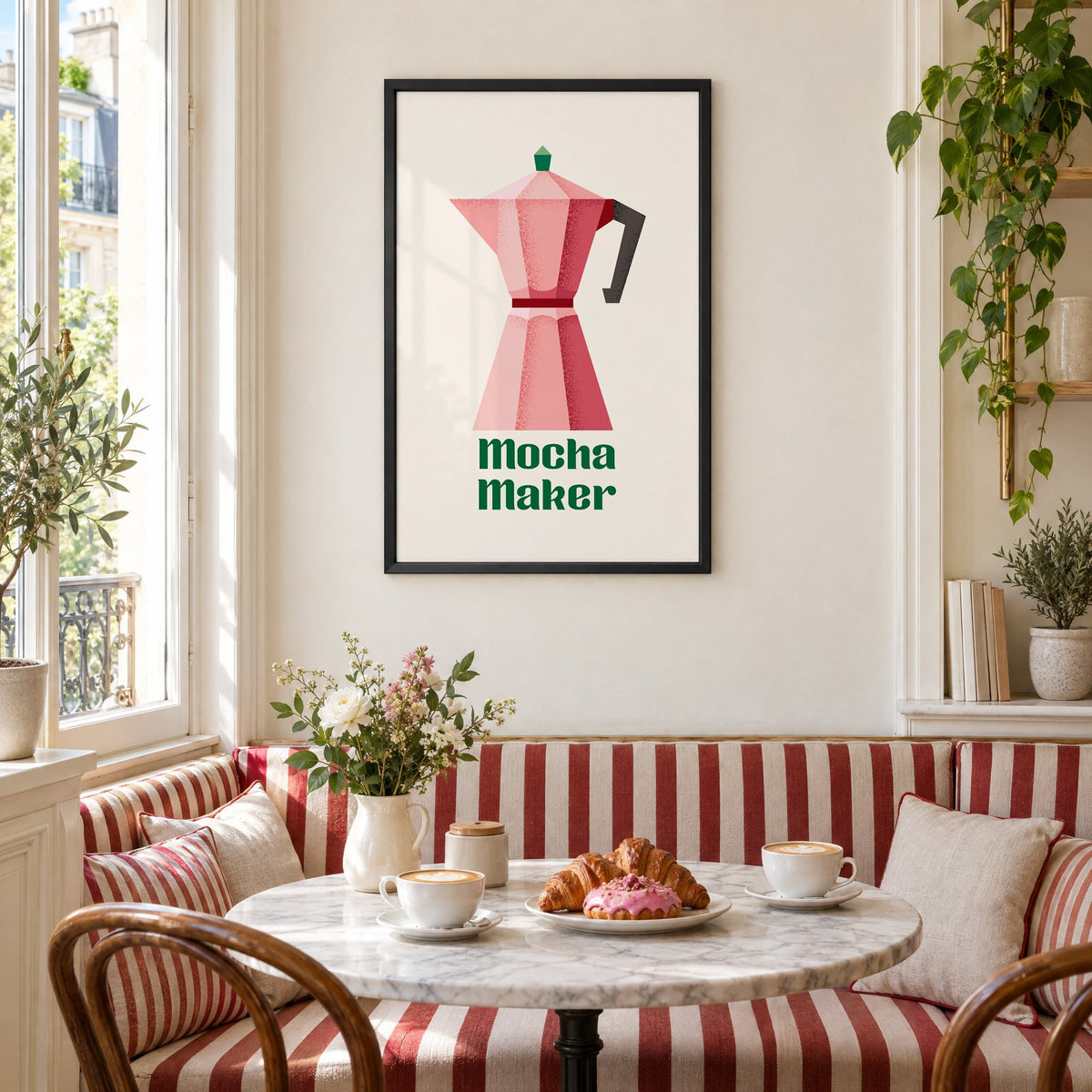 Mocha Maker pink moka pot print in a black frame above a striped cafe breakfast nook with cappuccino and pastries