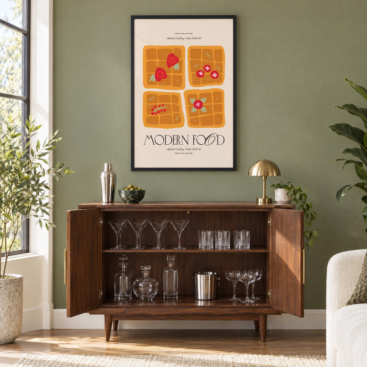 MODERN FOOD four berry waffles print in a black frame on an olive green wall above a walnut bar cabinet with glassware