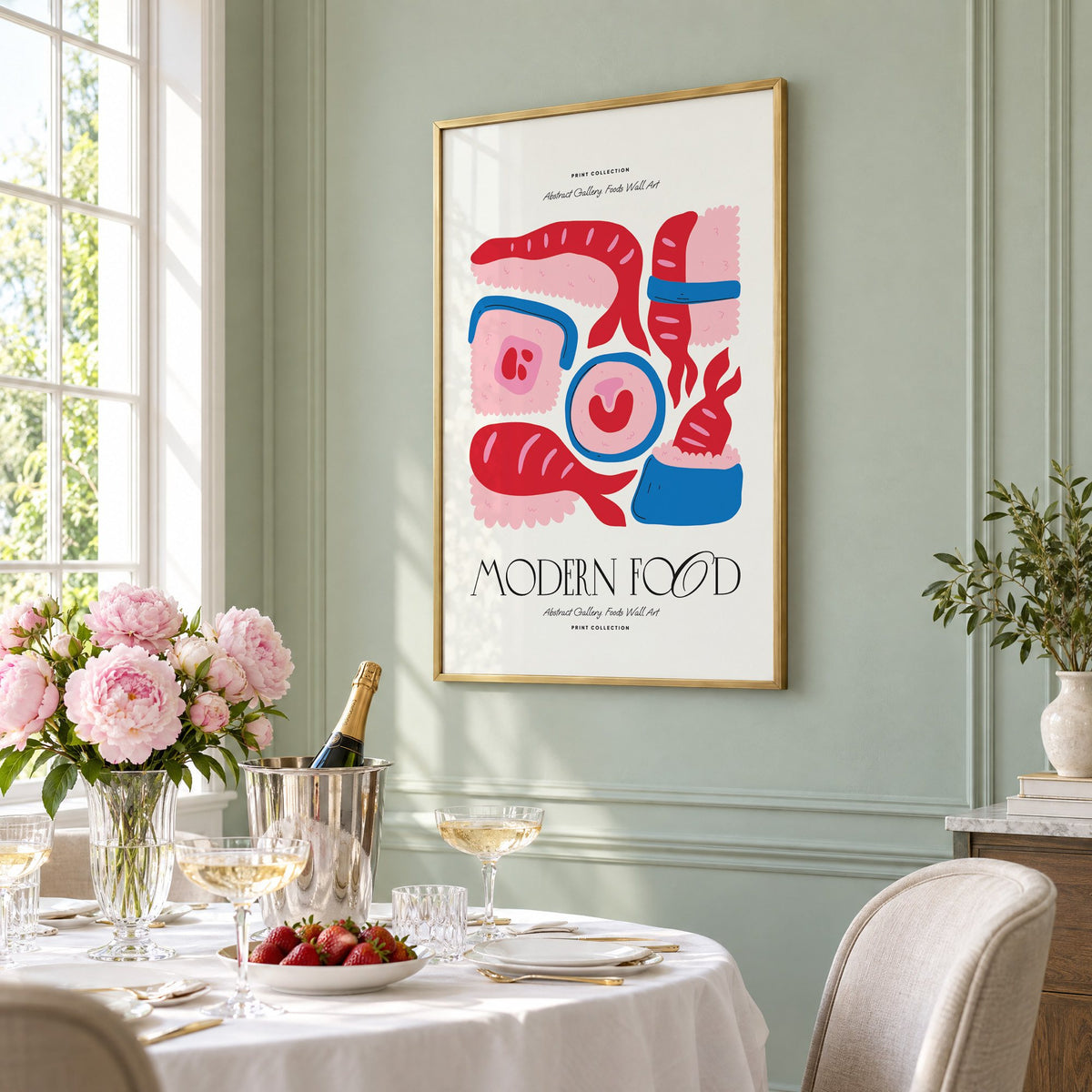 MODERN FOOD sushi nigiri maki print in a brass frame on a sage wall above a brunch table with champagne and peonies, seen at an angle