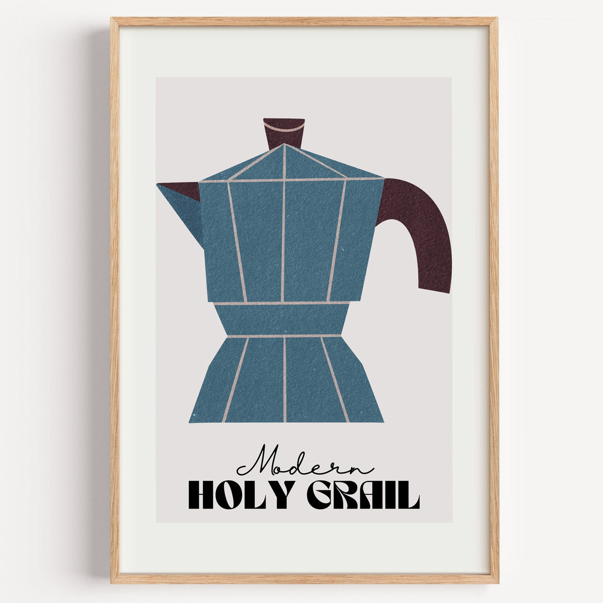 Modern Holy Grail moka pot print in a light oak frame on a plain white wall