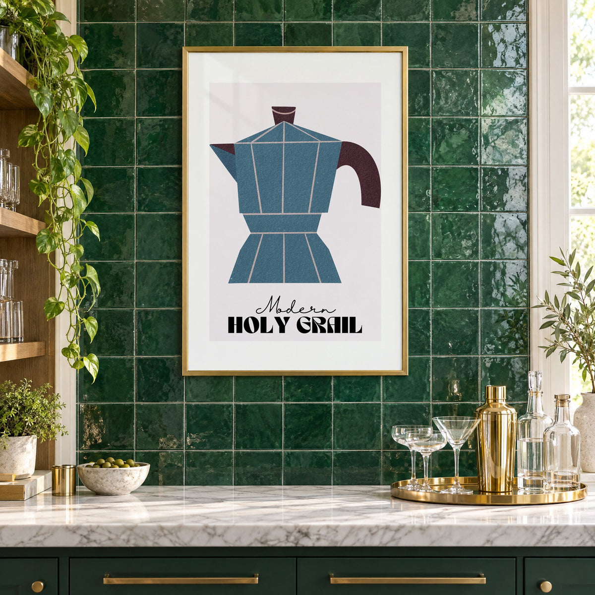 Modern Holy Grail moka pot print in a brass frame on emerald green tiles above a home bar with coupe glasses