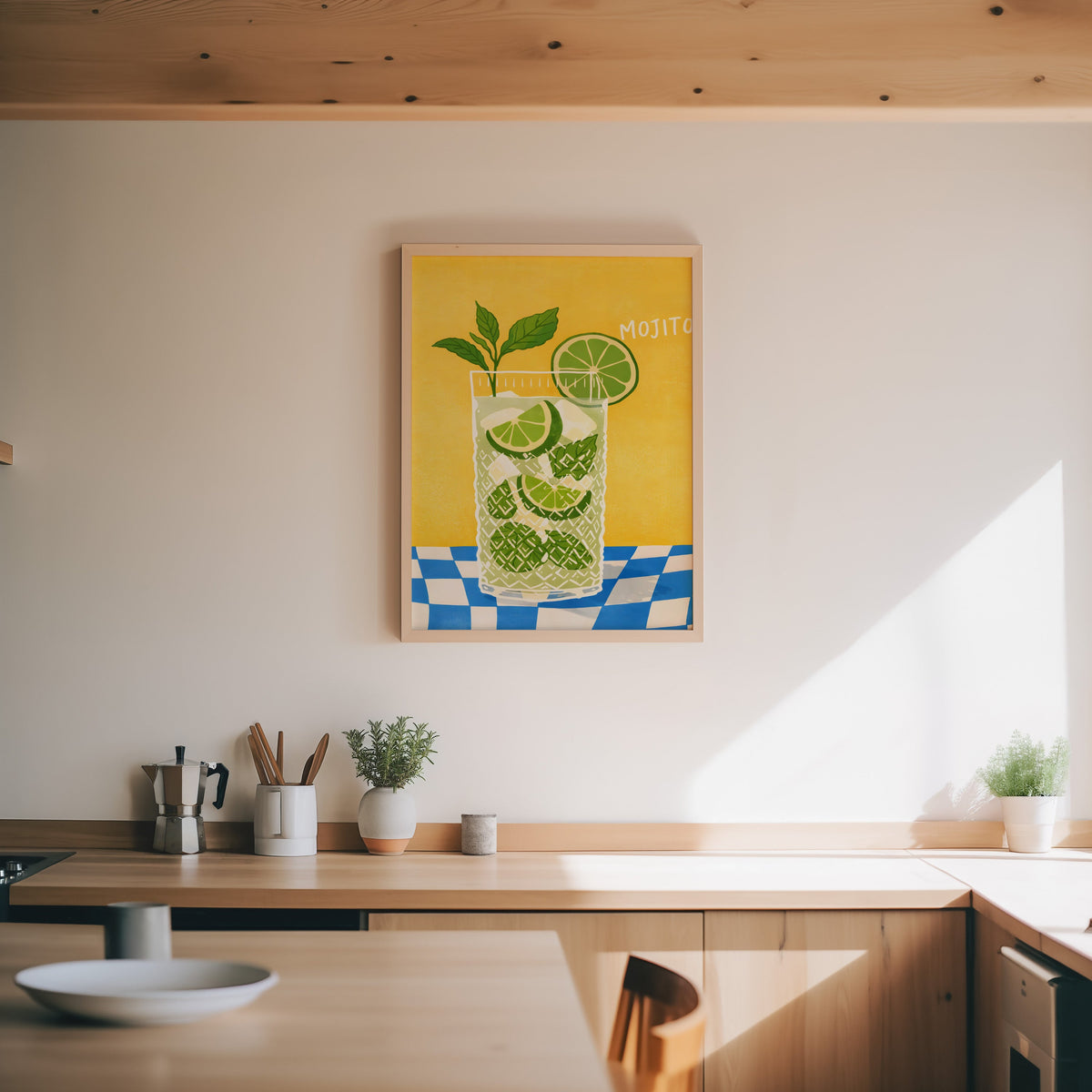 Mojito print in an oak frame above a wood counter with a moka pot and herbs