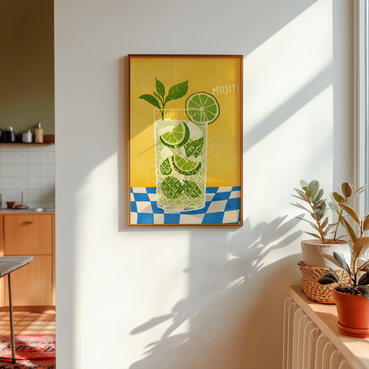 Mojito print in a gold frame in sunlight with plants and a kitchen beyond
