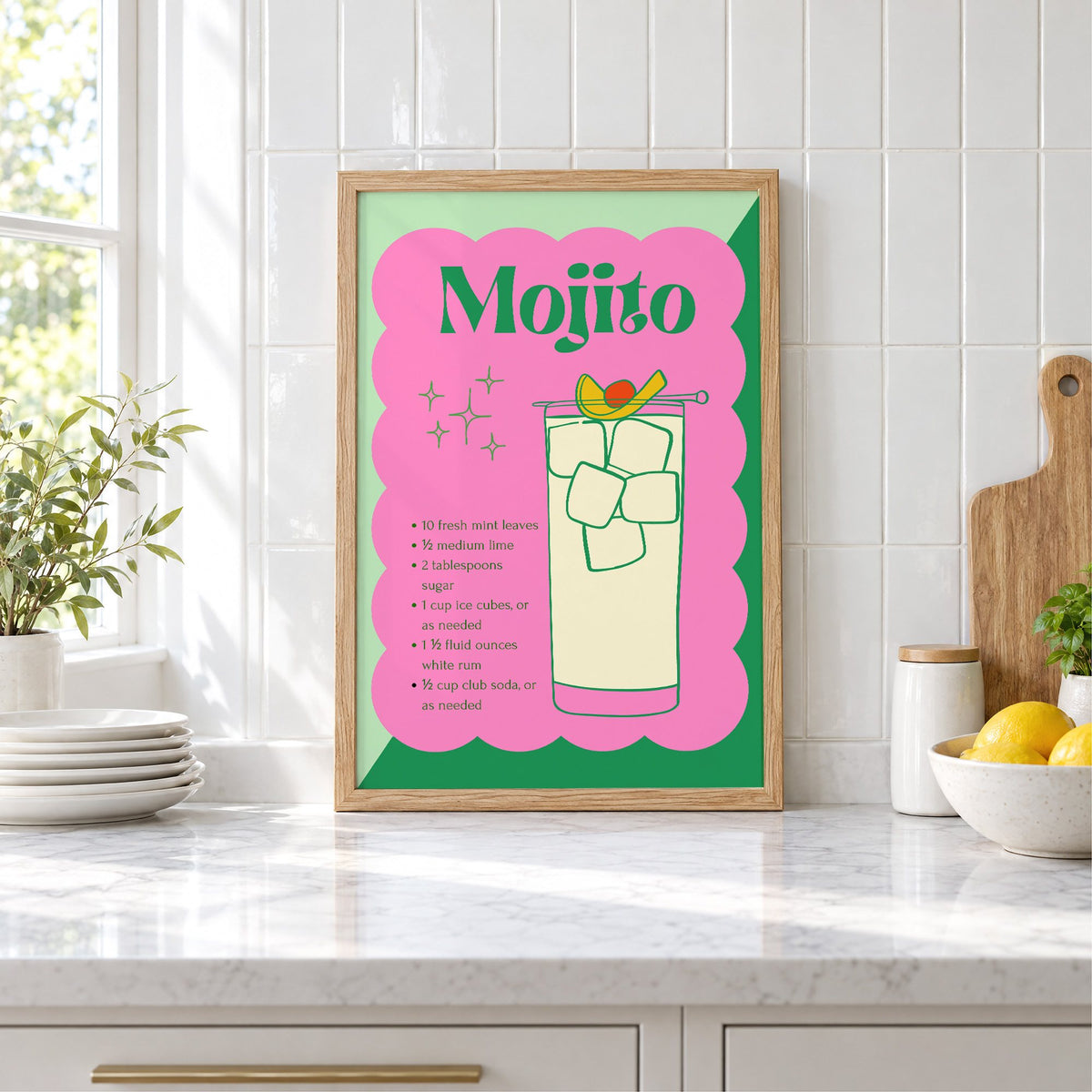 Mojito recipe retro scalloped print in an oak frame leaning on a marble counter by white tiles and lemons