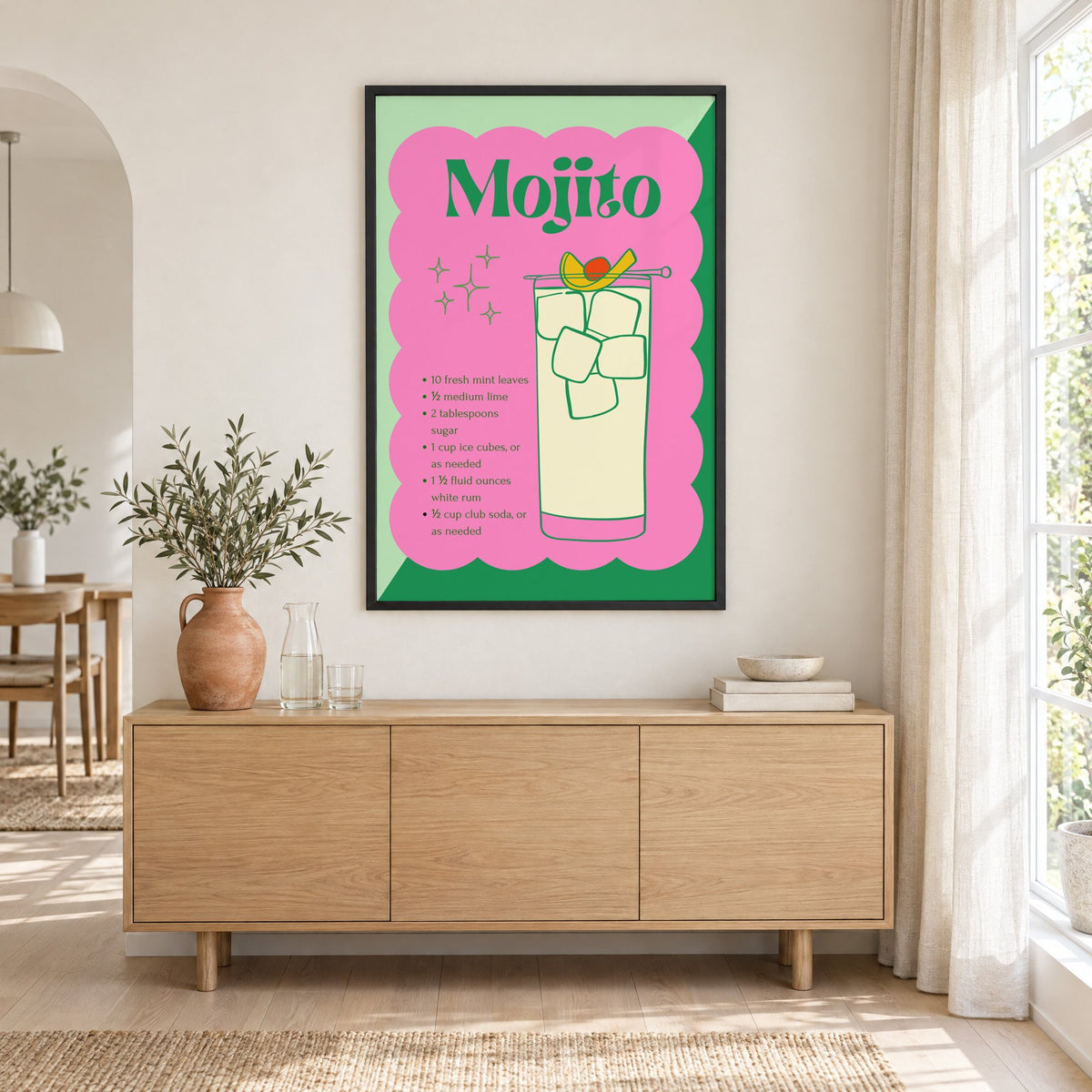Mojito recipe retro scalloped print in a black frame above an oak sideboard with a terracotta vase of olive branches