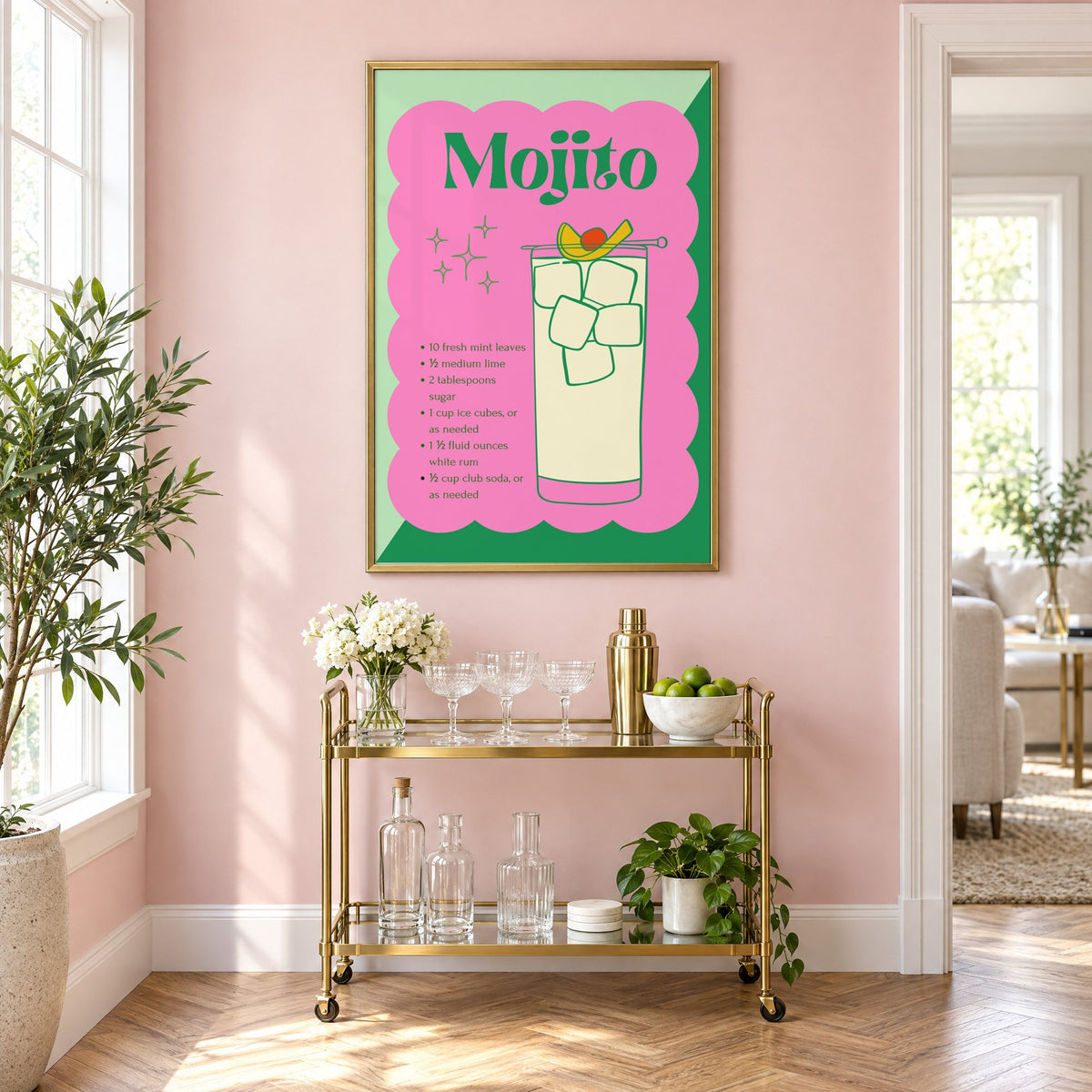 Mojito recipe retro scalloped print in a brass frame above a gold bar cart on a blush pink wall