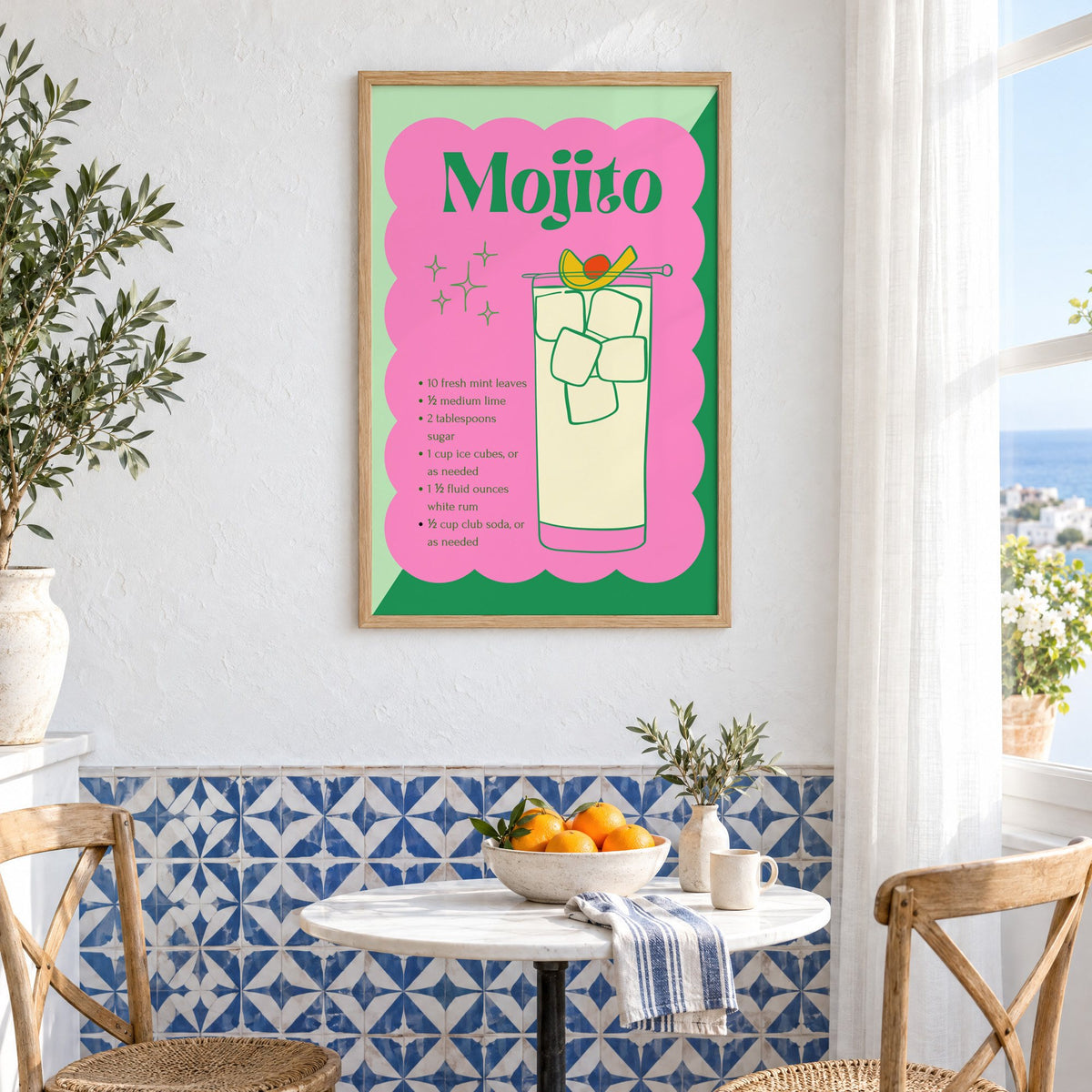 Mojito recipe retro scalloped print in an oak frame above a bistro table and blue patterned tiles