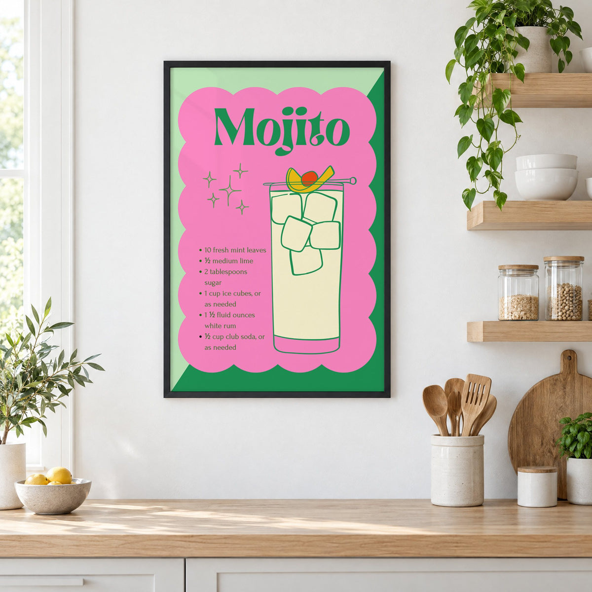 Mojito recipe retro scalloped print in a black frame in a white kitchen beside open wood shelves and glass jars