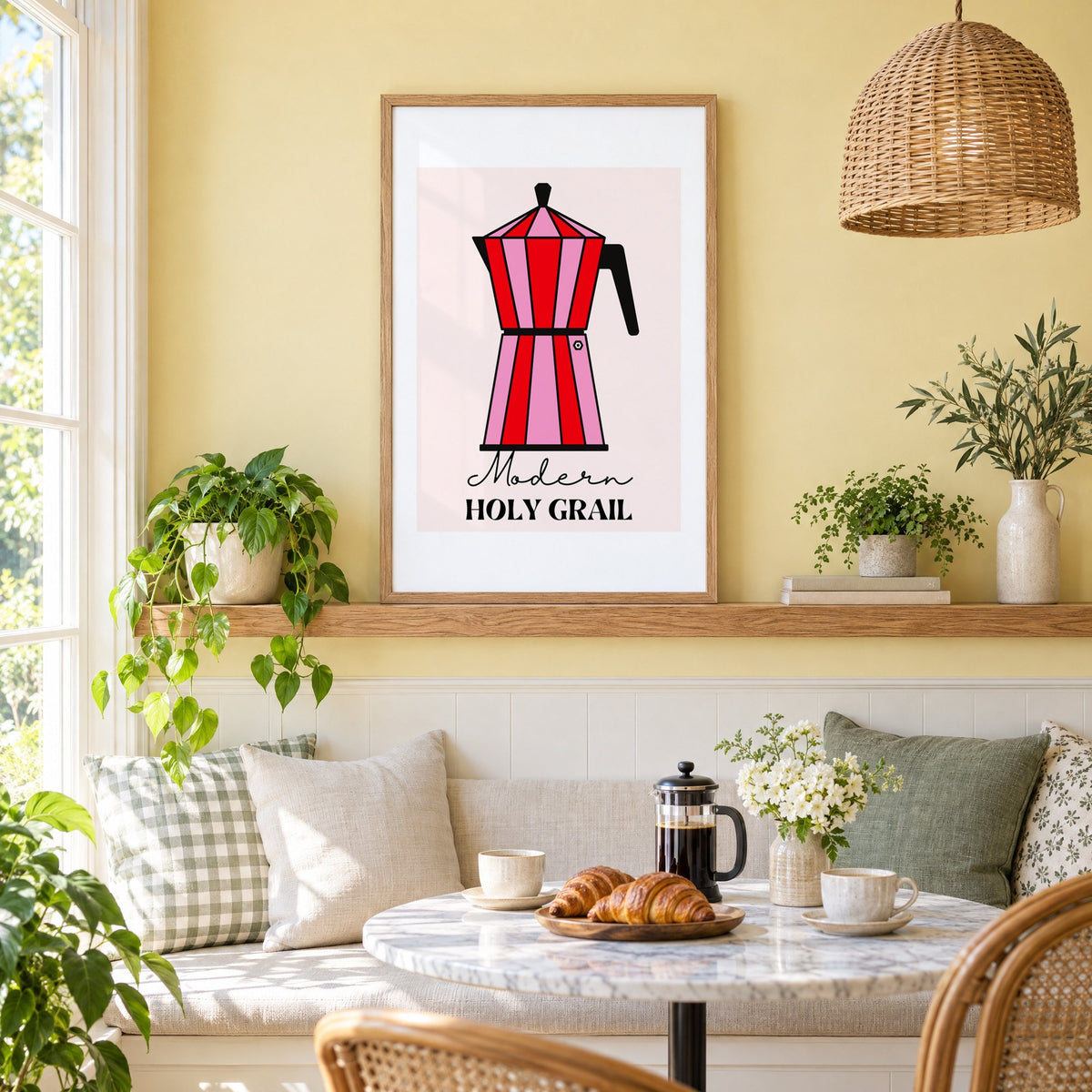 Moka pot pink and red striped print in an oak frame on a picture ledge above a sunny breakfast nook