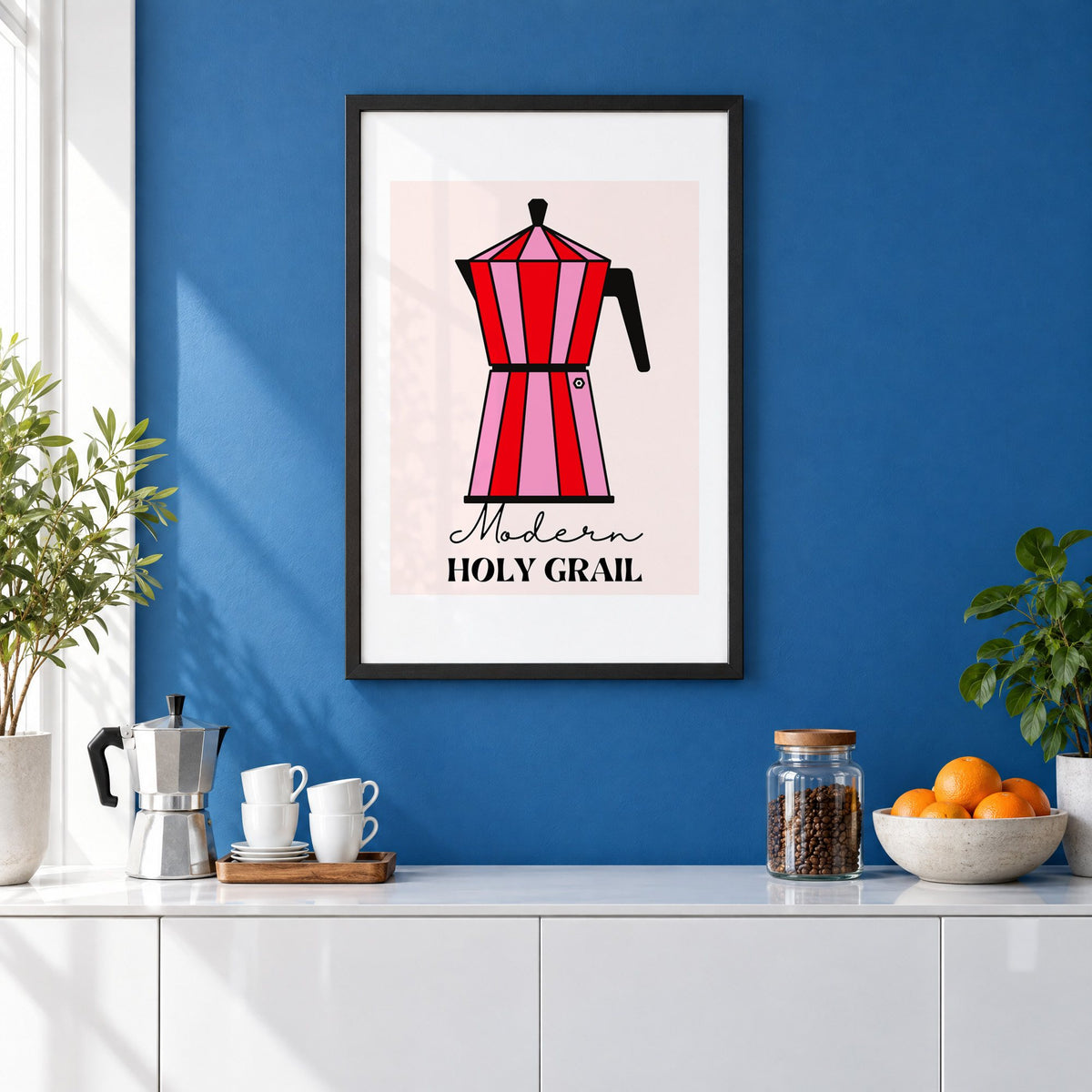Moka pot pink and red striped print in a black frame on a cobalt blue wall above a coffee station
