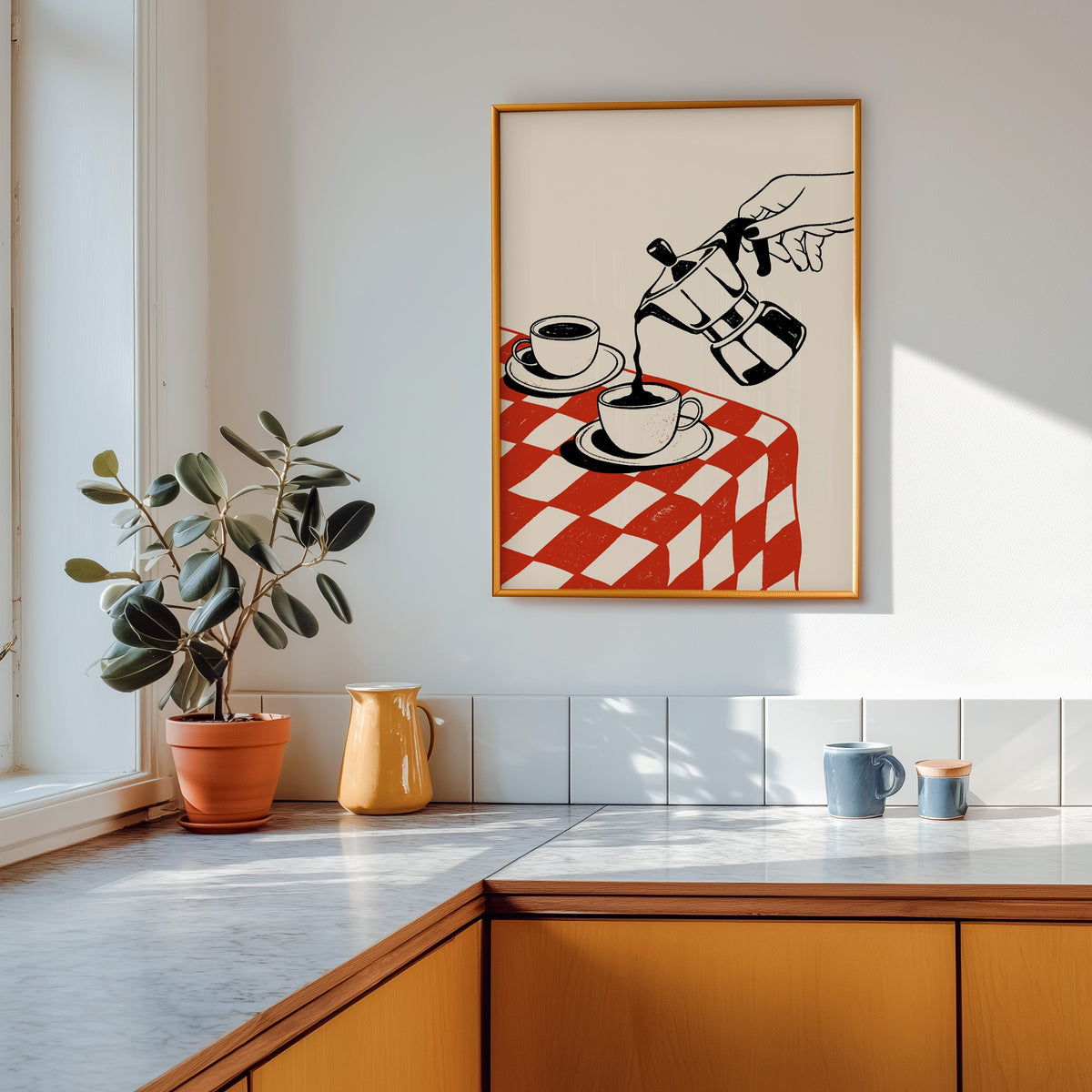 Moka pot print in a gold frame above a marble counter with a yellow ceramic jug