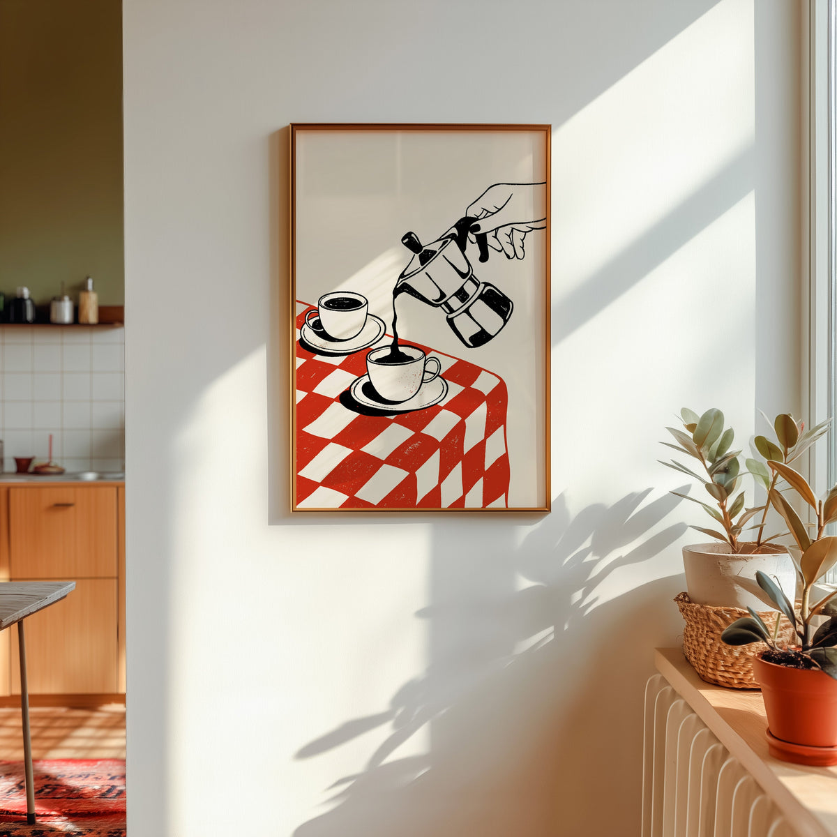 Moka pot print in a gold frame in sunlight with plants and a kitchen beyond