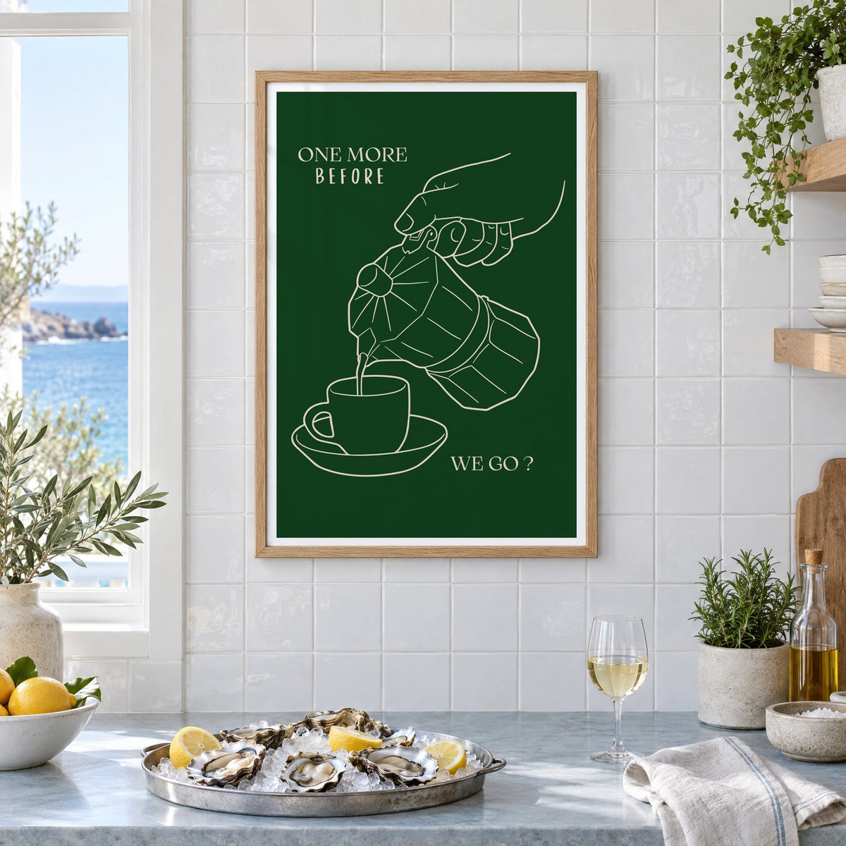 ONE MORE BEFORE WE GO? moka pot line print in an oak frame on white tiles above a marble counter with oysters and lemons by a sea view