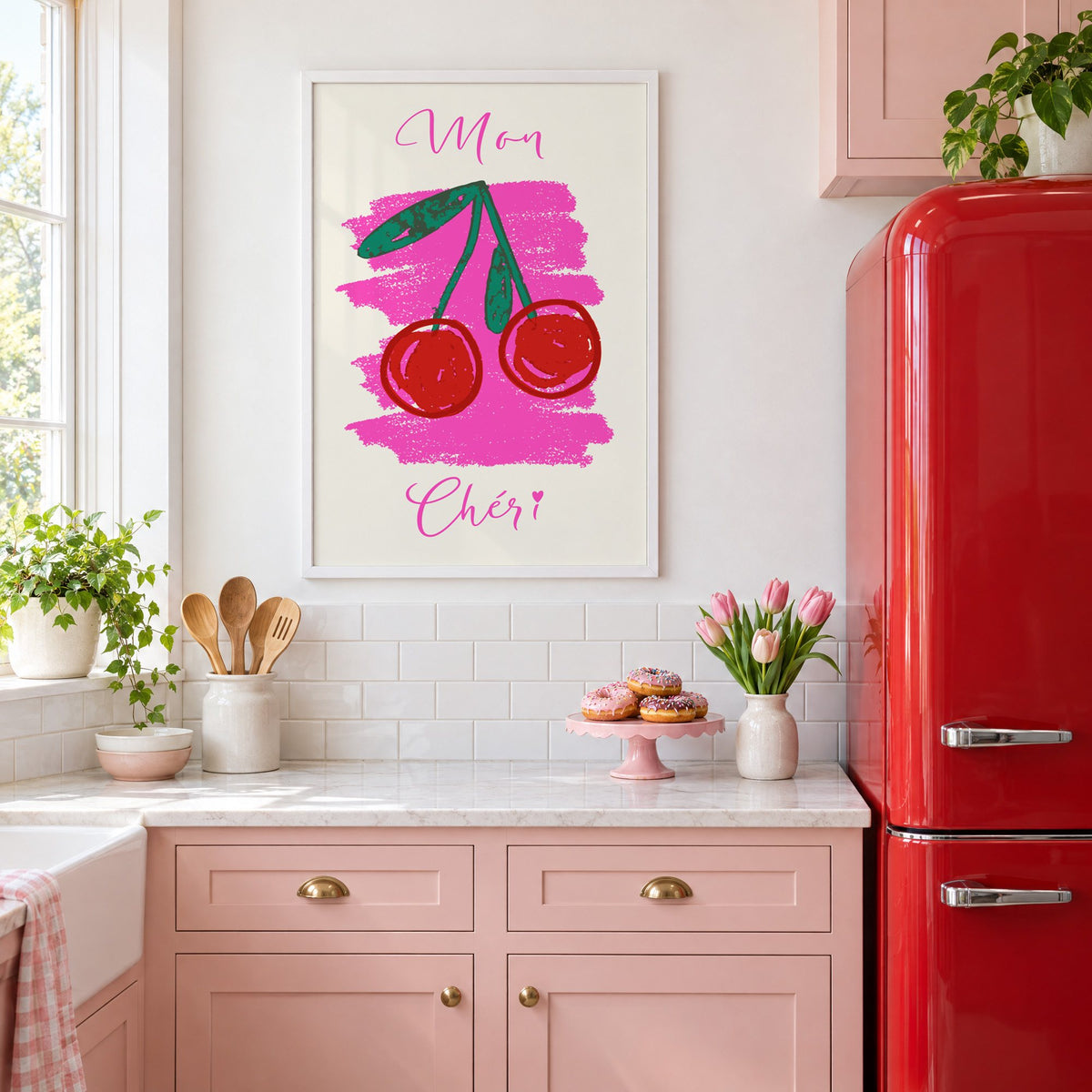 Mon Chéri cherries crayon print in a white frame in a pink kitchen beside a red retro fridge