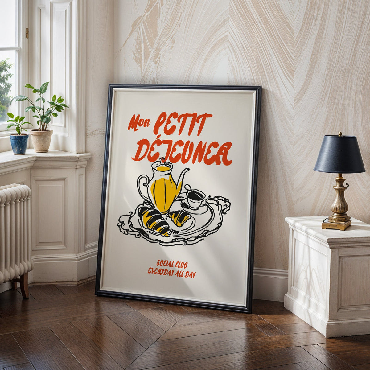 Mon Petit Dejeuner croissants print in a black frame on a dark herringbone floor