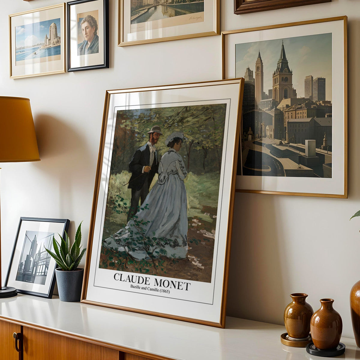 Monet woodland print shown in a gold frame leaning on a sideboard in a gallery wall