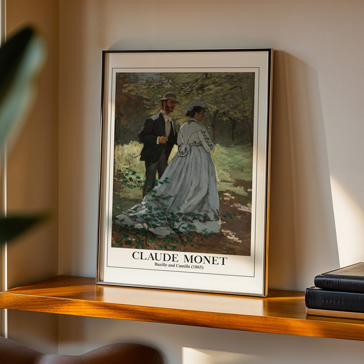 Bazille and Camille print in a black frame on a walnut shelf in evening light