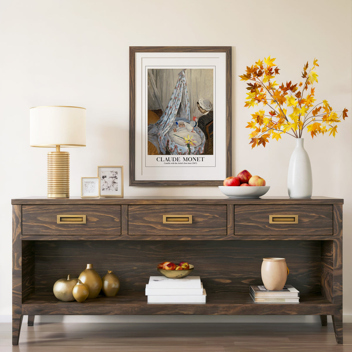 Monet cradle painting in a walnut frame above a console with autumn branches