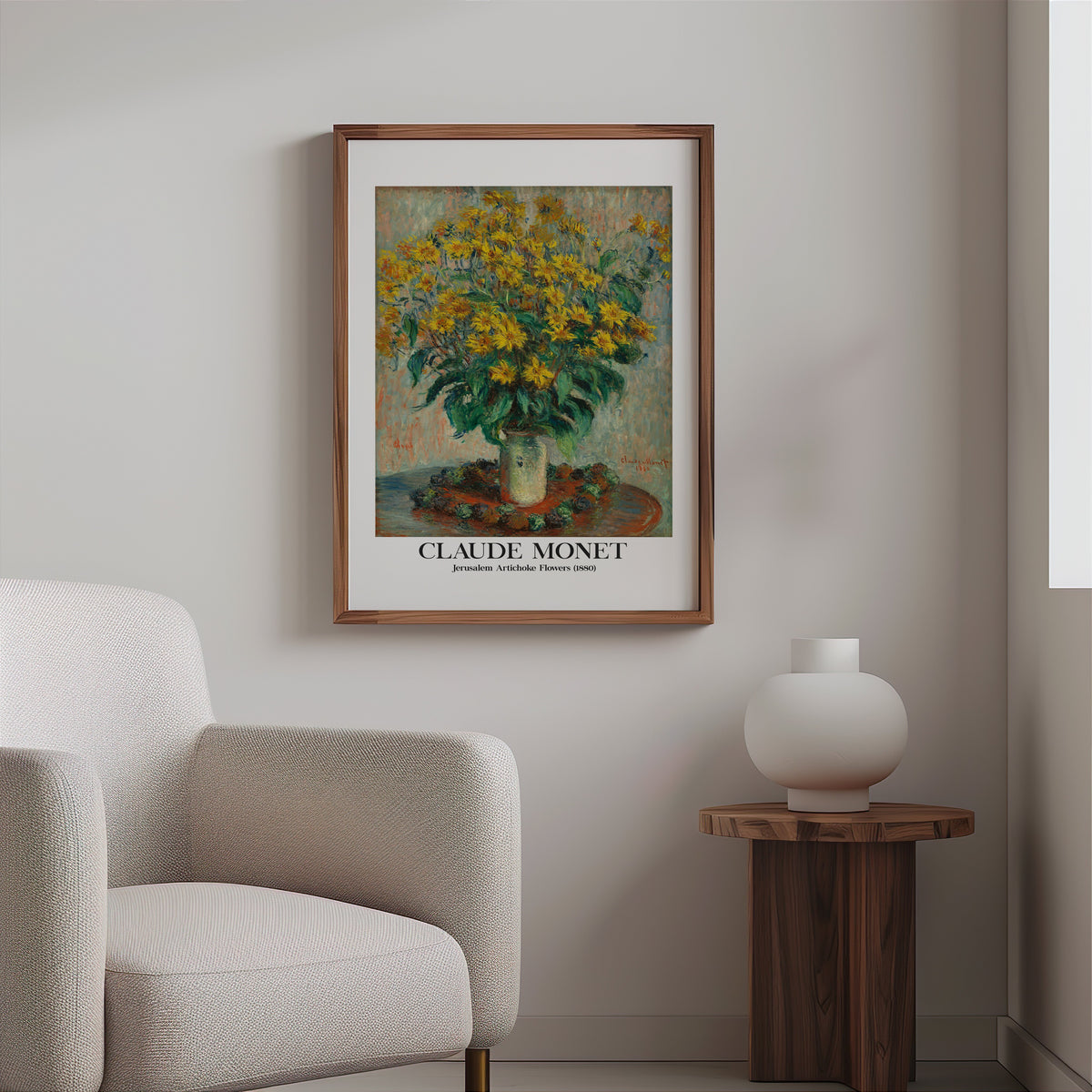 Monet yellow flower print in a slim walnut frame above a bouclé armchair