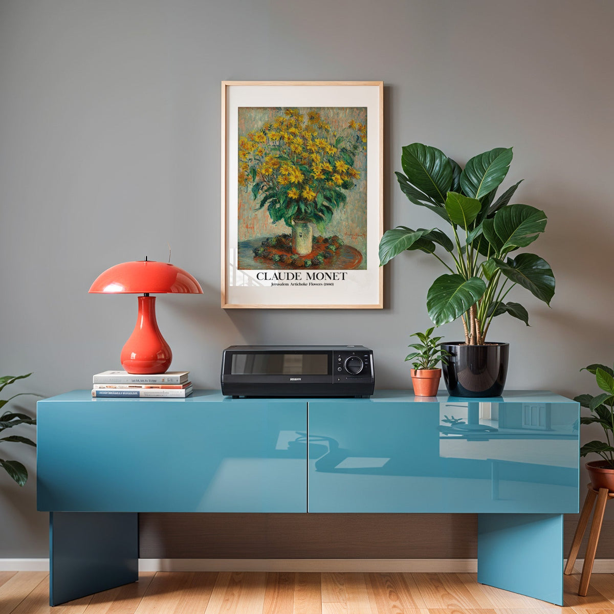 Monet floral poster in an oak frame above a teal sideboard with a red lamp