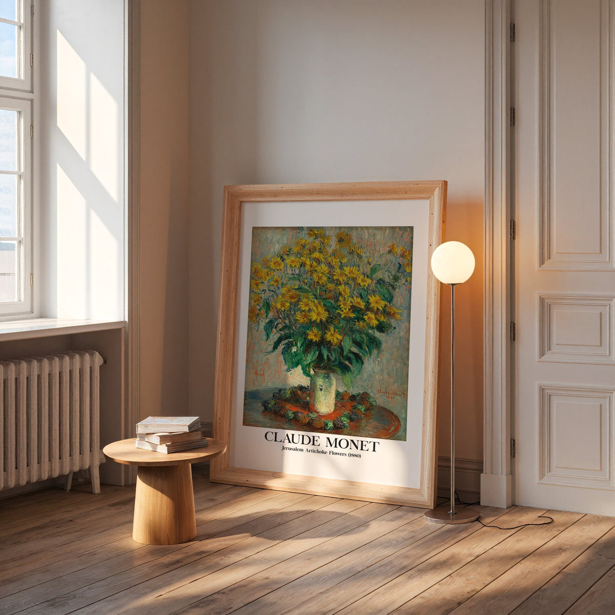 Monet flower print in a wide pine frame leaning by a sunlit window