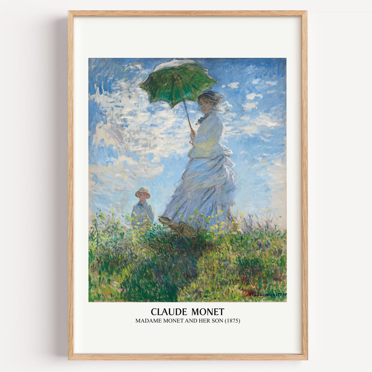 Monet Madame Monet and Her Son print in a light oak frame on a plain white wall