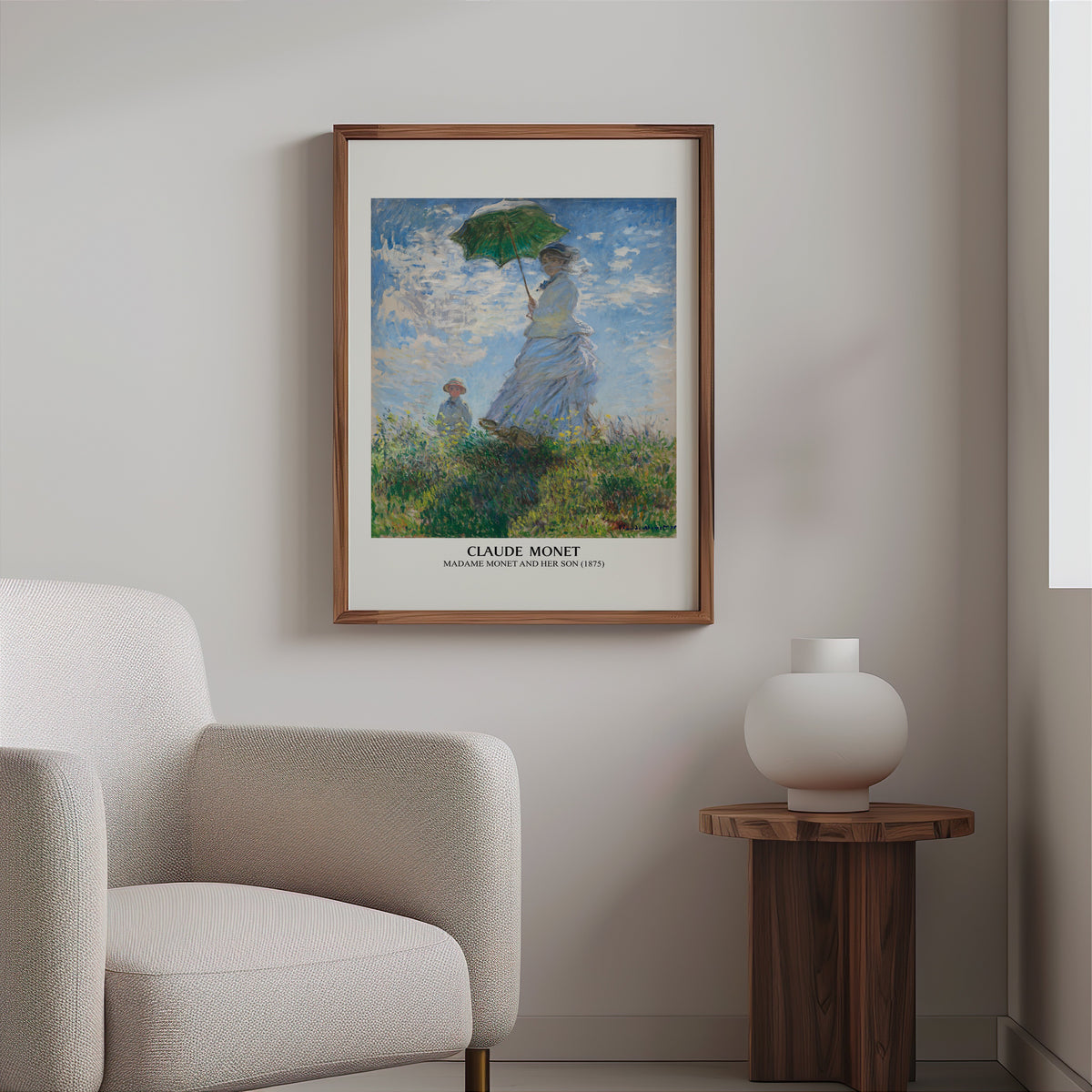 Monet parasol print in a slim walnut frame above a bouclé armchair