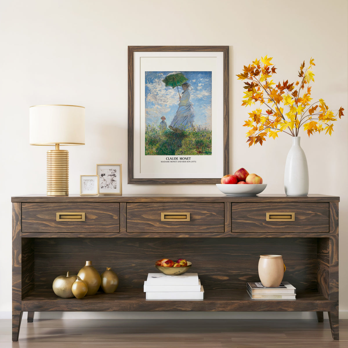 Madame Monet print in a walnut frame above a console with autumn branches