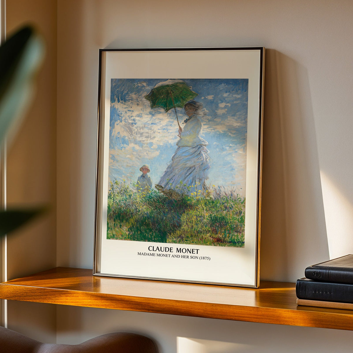 Madame Monet print in a black frame on a walnut shelf in evening light
