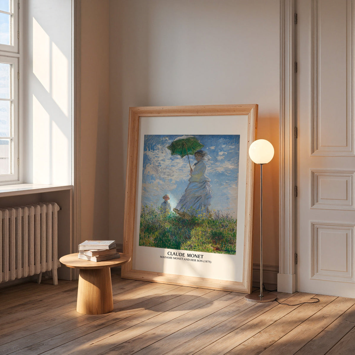 Monet parasol print in a wide pine frame leaning by a sunlit window