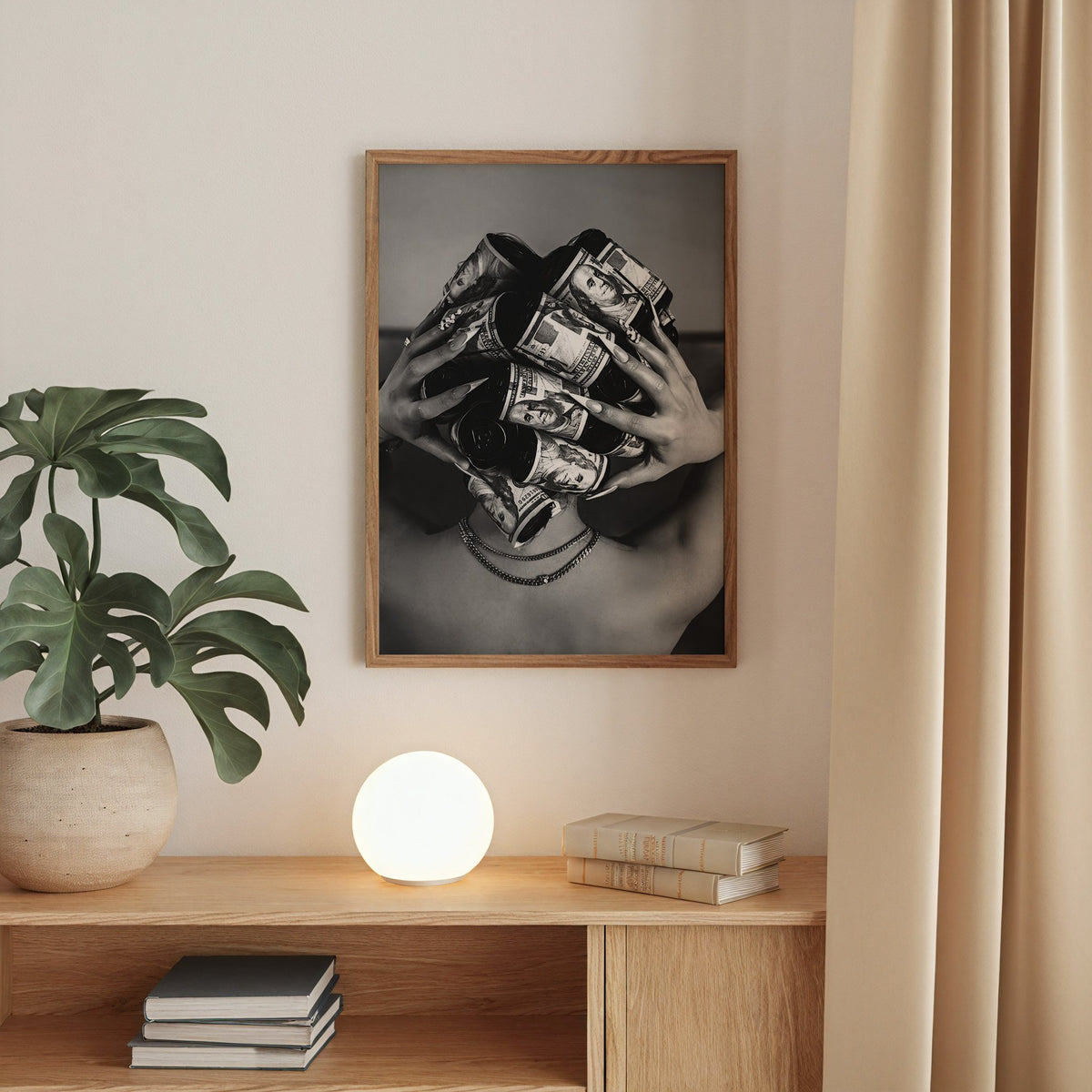 Hair curlers wrapped in dollar bills from behind print in a walnut frame above an oak cabinet with a glowing globe lamp