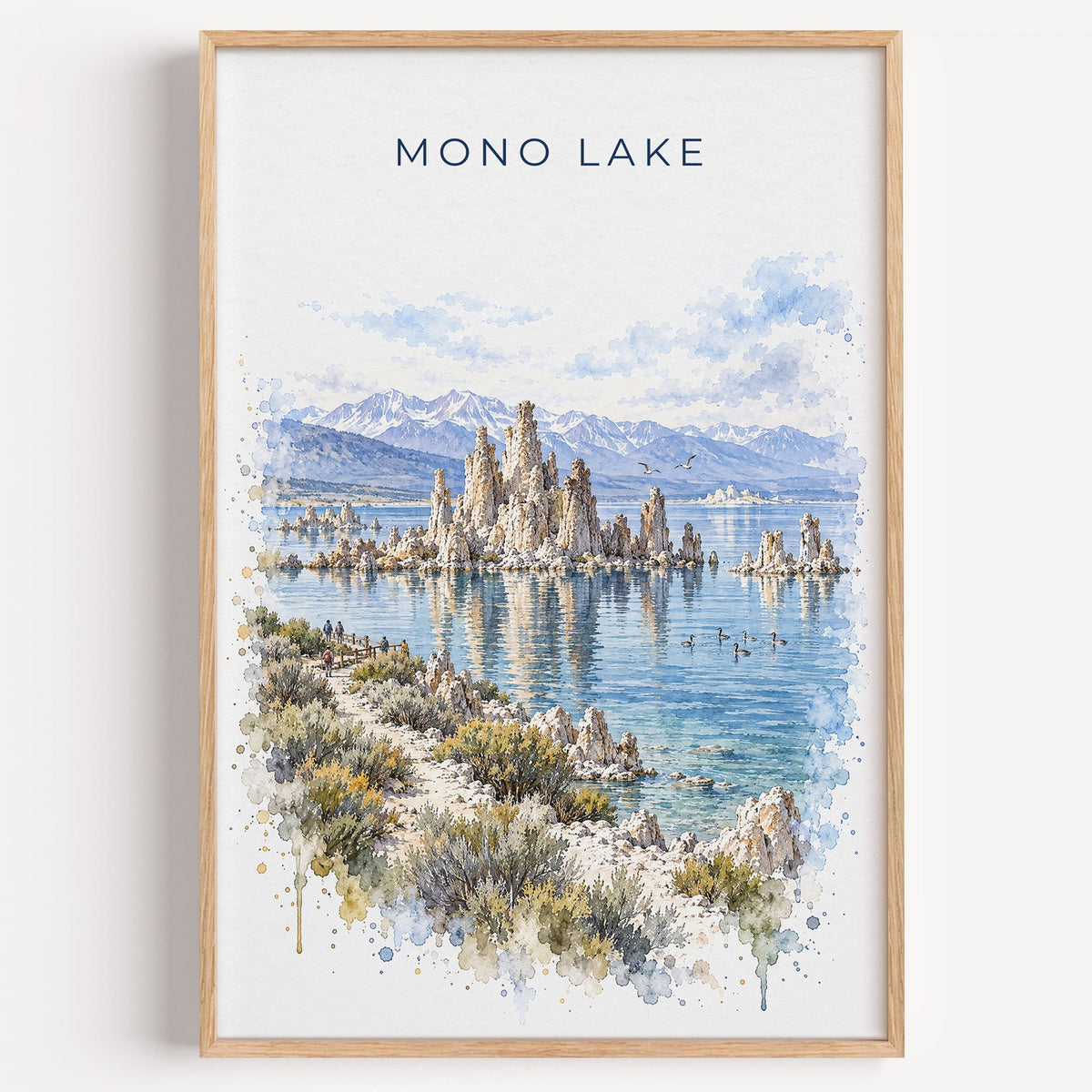 Mono Lake watercolor print in a light oak frame on a plain white wall