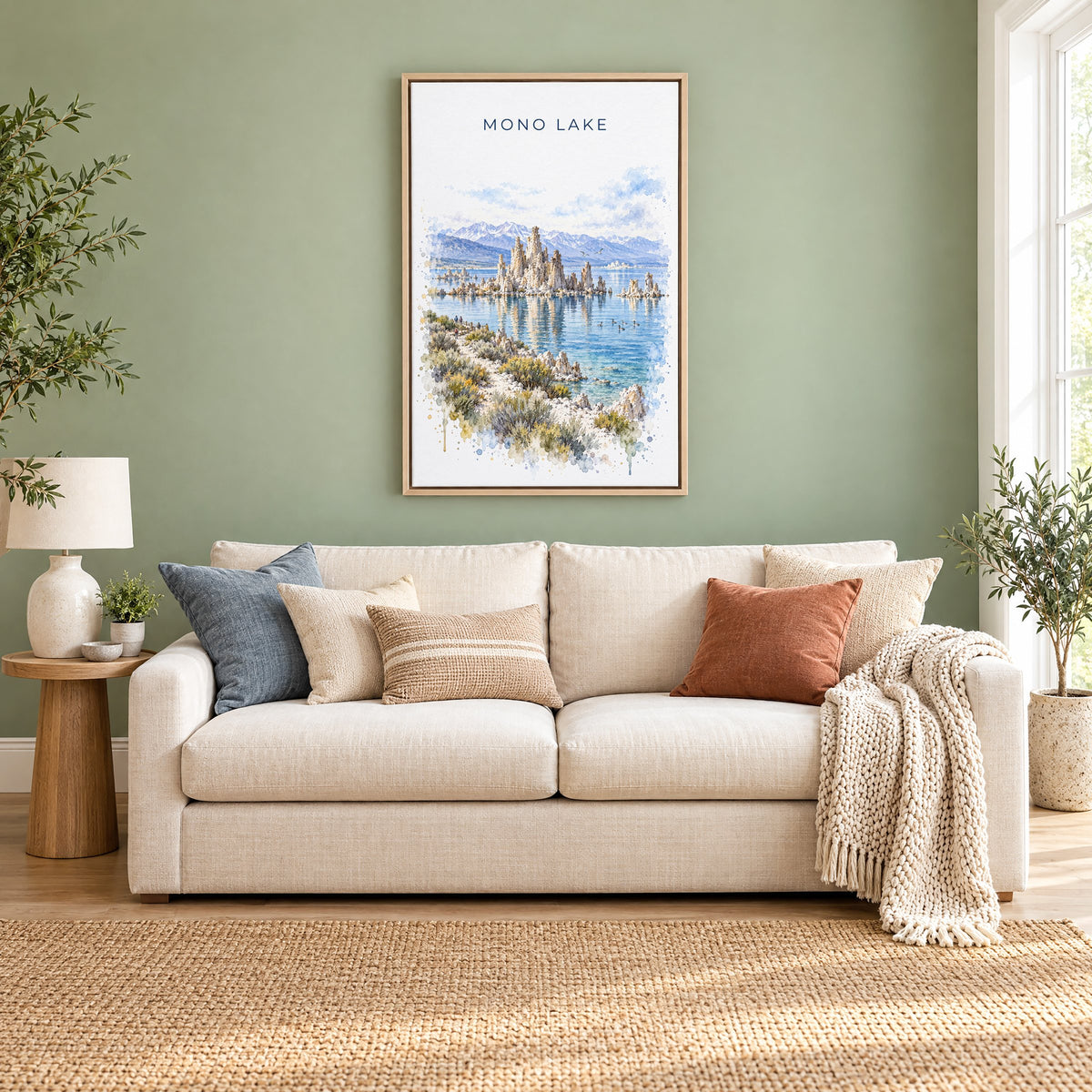 Mono Lake watercolor print as a natural floater canvas above a cream linen sofa on a sage green wall