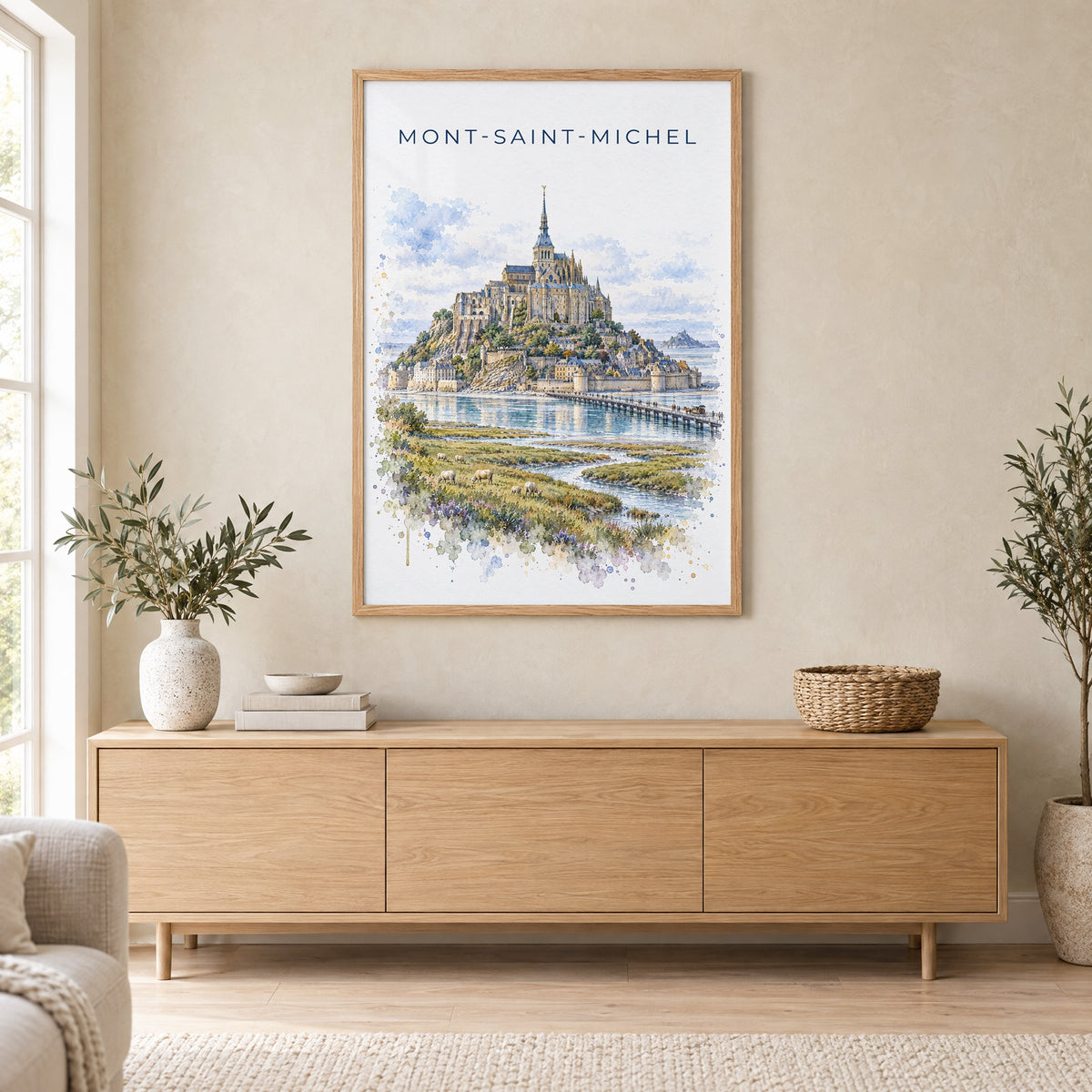 Mont-Saint-Michel watercolor print in an oak frame above a light wood sideboard in a Scandinavian living room